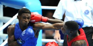 Jamaica's Michael Gardener (left) is hit with a right to the head by Zambia's Benny Muziyo in a men's 75Kg preliminary fight at the Commonwealth Games. Gardener was defeated by Muziyo at the Scottish Exhibition and Conference Centre. - Ricardo Makyn/Staff Photographer