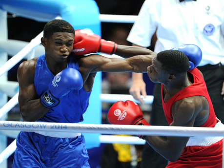 Jamaica's Michael Gardener (left) is hit with a right to the head by Zambia's Benny Muziyo in a men's 75Kg preliminary fight at the Commonwealth Games. Gardener was defeated by Muziyo at the Scottish Exhibition and Conference Centre. - Ricardo Makyn/Staff Photographer