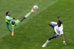 Nigeria's Juwon Oshaniwa, left, and France's Paul Pogba challenge for the ball during the World Cup round of 16 soccer match between France and Nigeria