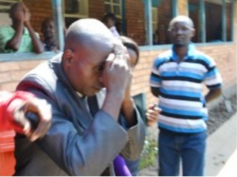 HOLY Fire Christian Ministry Church Bishop Dominic Nyondo shielding his face from cameras at the Kitwe magistrate’s court after he appeared for defilement yesterday. Picture by MOFFAT CHAZINGWA. HOLY Fire Christian Ministry Church Bishop Dominic Nyondo shielding his face from cameras at the Kitwe magistrate’s court after he appeared for defilement yesterday. Picture by MOFFAT CHAZINGWA.