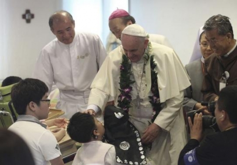 Pope Francis blesses a disabled child during his visit to the rehabilitation center for disabled people at Kkottongnae in Eumseong, August 16, 2014. Pope Francis blesses a disabled child during his visit to the rehabilitation center for disabled people at Kkottongnae in Eumseong, August 16, 2014.