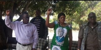 Secretary General Wynter Kabimba, Zambezi West PF candidate Christabel Ngimbu and her campaign manager Wilbur Simuusa sing the national anthem at a meeting