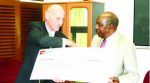 FINANCE Minister Alexander Chikwanda (right) receives a dummy cheque from Zanaco managing director Bruce Dick at the Ministry of Finance in Lusaka yesterday. Picture by CLEVER ZULU