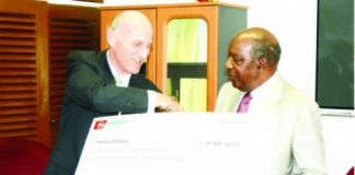 FINANCE Minister Alexander Chikwanda (right) receives a dummy cheque from Zanaco managing director Bruce Dick at the Ministry of Finance in Lusaka yesterday. Picture by CLEVER ZULU