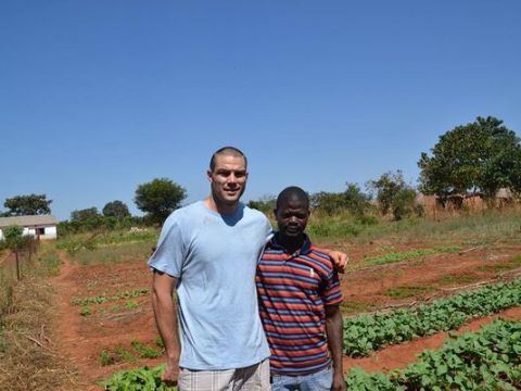 Mickey Kinzenbaw with Zambian resident Chimbaza Mbewe, who was trained by members of the Ankeny Free Church to grow his own crops. (Photo- Mickey Kinzenbaw:Special to the Register ) Mickey Kinzenbaw with Zambian resident Chimbaza Mbewe, who was trained by members of the Ankeny Free Church to grow his own crops. (Photo: Mickey Kinzenbaw/Special to the Register )