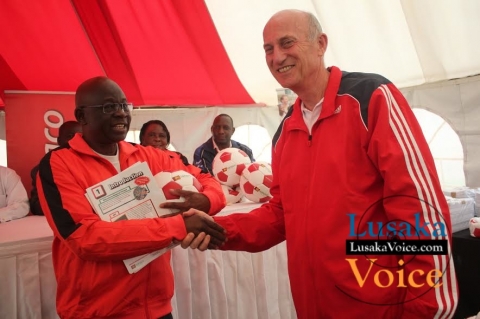 Ministry of Education and Early Childhood  PS Dr Patrick Nkanza receiving from Zanaco MD Dick Bruce some soccer balls meant to selected Lusaka based primary schools ,the ceremony took place at the ZANACO Sunset Stadium