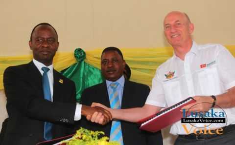 The Lusaka City Mayor Mulenga Sata exchanging documents with the ZANACO MD Dick Bruce while looking on is Deputy Minister of Local Government  and Housing  Nicolas Banda during launch between  Zanaco and Lusaka City Council  Direct Debit and Credit Clearing  (DDACC) at the Nkatindi Hall