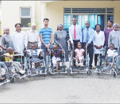 A group photo of the children recipients of wheelchairs, parents, Management of Cardinal Distributors , Sisters and Members of staff of the Zambia Italian Hospital