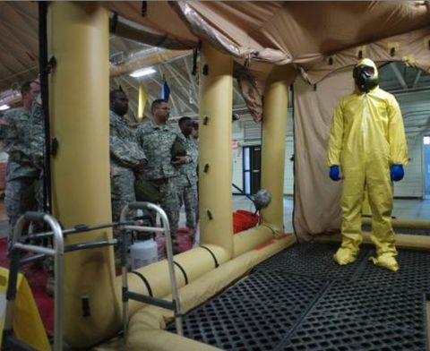 A soldier goes through the decontamination process with U.S. Army soldiers from the 101st Airborne Division (Air Assault), who are earmarked for the fight against Ebola, take part in training before their deployment to West Africa, at Fort Campbell, Kentucky October 9, 2014.