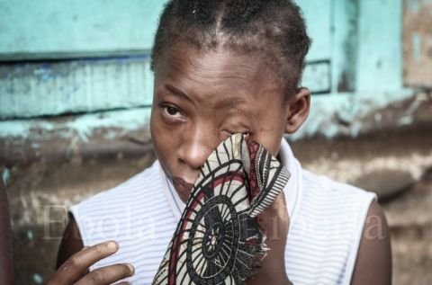 A young girl cries as her mother is taken away - Ebola crisis in Liberia