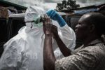 Adjusting a pair of protective goggles before the burial team sets off – Ebola crisis in Liberia