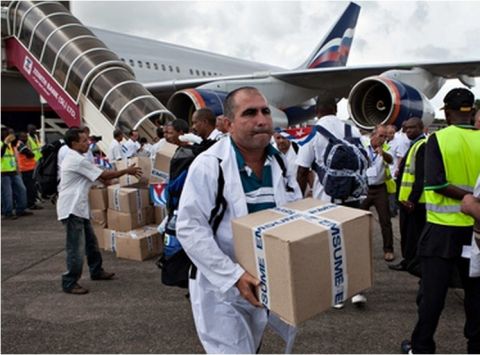 Cuban doctors and health workers arrive at Freetown's airport to help the fight against Ebola in Sierra Leone. Photograph: Florian Plaucheur/AFP/Getty Images