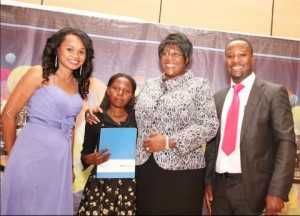 First Lady Dr Christine Kaseba presents the ABE Scholarship award to Purity Chitala to study Business management at ZCAS during the 2014 ZNBC: ZICTA Debate Time