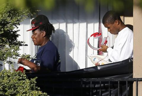People leave the apartment unit where Thomas Eric Duncan, a Liberian citizen diagnosed with the Ebola virus had been staying, in Dallas, Texas, October 3, 2014.