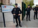 Police stand at the entrance of the Carlos III hospital in Madrid. Photograph: Paul Hanna/Reuters