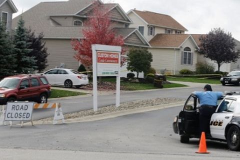 Police watch over a house on Thursday in Tallmadge, Ohio where Amber Vinson, the other US nurse to contract Ebola, stayed. Photograph: Tony Dejak/AP