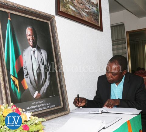 FAZ President Kalusha Bwalya; FAZ spokesperson Nkweto Tembwe sign book for Sata