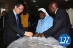 from left to right- ZTE Managing Director Billy Yi, Former ZESCO MD Cyprian Chitundu and Kasisi Girls Head Teacher Sr Prisca Phiri unveiling one of the electric pots! - Photo Credit Jean Mandela - Lusakavoice.com