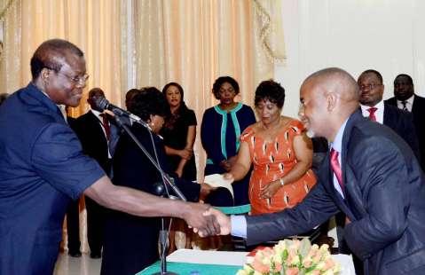 Acting President Ngosa Simbyakula congratulates Lusaka Province Permanent Secretary Stardy Mwale during the Swearing-In-Ceremony at State House on March 13,2015 -Picture by THOMAS NSAMA