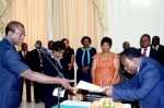 Acting President Ngosa Simbyakula receives an affidavit of Oath from Muchinga Province Permanent Secretary Bright Nundwe (r) during the Swearing-In-Ceremony at State House on March 13,2015 -Picture by THOMAS NSAMA