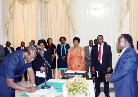 Acting President Ngosa Simbyakula signs on the affidavit of Oath of Muchinga province permanent Secretary Bright Nundwe (r) during the Swearing-In-Ceremony at State House on March 13,2015 -Picture by THOMAS NSAMA