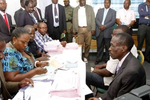 Chawama Constituency PF Parliamentary Candidate Lawrence Sichalwe filling in his nomination papers for Chawama Constituency by Elections Slated for April 14. This was at Chawama Basic school in Lusaka on March 10,2015 -Picture by THOMAS NSAMA / State House