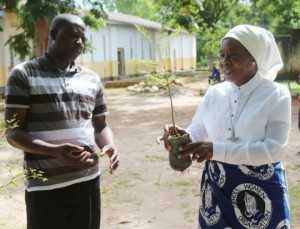 Chongwe Paris priest Fr Gabriel Mwanamwalye and Chieftness Nkomesha Mukambo II admiring a tree before plantation