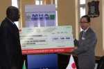 Japanese Ambassador to Zambia, Koishi Koinuma, presenting a US$1.5 million cheque to Home Affairs Minister, Davis Mwila in Lusaka, Zambia on Tuesday 24 March 2015. The funds will go towards the refugee and local integration programme in Zambia. Picture courtesy of UNHCR