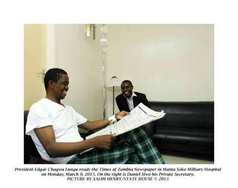 President Edgar Lungu reads the Times of Zambia Newapaper in Maina Soko Military Hospital on Monday, March 9,2015. On the right is Daniel Siwo, his Private Secretary -Picture by SALIM HENRY