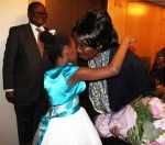 Zambia Vice-President Her Honour Mrs Inonge Wina (right) hugs eight-year-old Tasheni Bota on arrival at New York Palace Hotel in New York on Sunday, March 8, 2015. Looking on is Zambia’s Ambassador to the US His Excellency Mr. Palan Mulonda. The Vice-President is leading the Zambian delegation to the 59th Session of the Commission on the Status of Women. PHOTO | CHIBAULA D. SILWAMBA | ZAMBIA UN MISSION
