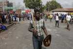 A man carries a club and a Zulu shield outside a hostel in Johannesburg(Siphiwe Sibeko:Reuters)