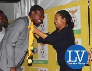 Kitwe based MTN entrepreneurship Manager Rebecca Mwila crowining Power Dynamos goal Keeper Joshua Titima with a sliver medal!  - Photo Credit Jean Mandela - Lusakavoice.com