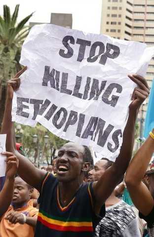 People power ... a man holds a placard during an anti-xenophobia march outside the City Hall of Durban on April 8. Picture: AFP Photo / Rajesh Jantilal Source: AFP