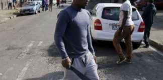 An African immigrant holds a machete in a run-down district of east Johannesburg(Siphiwe Sibeko/Reuters)