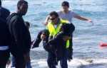 A man rescues a migrant from the Aegean sea on the island of Rhodes. Photograph- Argiris Mantikos:AP