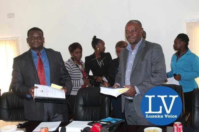 Buildcon CEO Moses Mubanga and RDA CEO Kanyuka Mumba - in a red tie- during the Chingola Solwezi Road construction Lot 2 contract signing ceremony at Mass Media area RDA offices