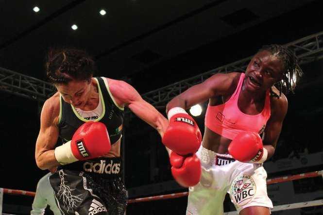 IRISH Christina McMahon in punch for punch with Zambian Catherine Phiri during the Female WBC Gold bout at Mulungushi International Conference Centre in Lusaka on Saturday. PICTURE- CHANDA MWENYA