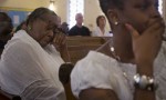 A woman cries during a memorial service at the St John’s Reformed Episcopal church Photograph- Carlo Allegri:Reuters