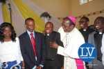 Lusaka Archdiocese Archbishop Telesphore George Mpundu joins newly ordained priests with Gender Minister Prof Luo Nkandu and Chiefs and Traditional Affairs Minister Joseph Katema  .. Jun 1, 2015