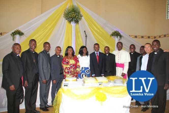 Lusaka Archdiocese Archbishop Telesphore George Mpundu ordains 11 priests at Lusaka Holy Cross Cathedral on Saturday, May 30th, 2015.   Archbishop joins his newly ordained priests in cutting a cake and thereafter joined them for  a family picture with Gender Minister Prof Luo Nkandu and Chiefs and Traditional Affairs Minister Joseph Katema.