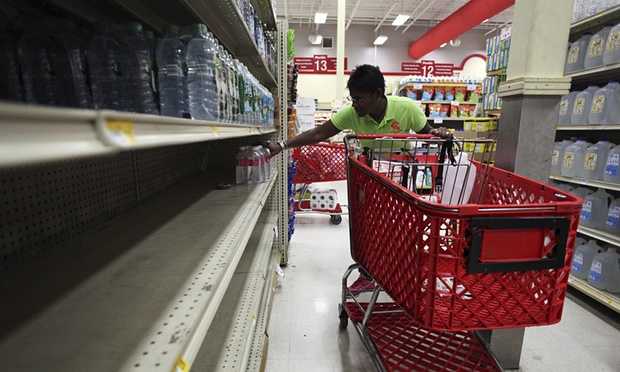 A woman shops for water on Thursday at a supermarket in preparation for tropical storm Erika in San Juan, Puerto Rico. Photograph- Alvin Baez:Reuters
