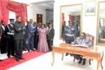 Malawi’s President Prof Peter Mutharika signs a visitors Book as President Edgar Lungu looks on after the bilateral Talks at State House on July 31,2015 -Picture by THOMAS NSAMA
