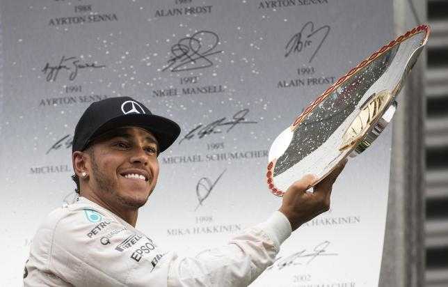 Mercedes Formula One driver Lewis Hamilton of Britain (L) celebrates his victory in the Belgian F1 Grand Prix in Spa-Francorchamps August 23, 2015. REUTERS:YVES HERMAN Lewis Hamilton