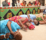 First Lady Esther Lungu, second from left, rolling on the ground thanking people for voting for her husband, President Edgar Lungu, in the January 20 elections. Photo credit - Zambian Watchdog.