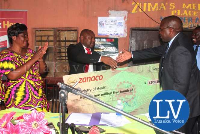 ZANACO Head of Retail Banking, Simon Chuma (c), hands over the Cheque to Minister of Health Dr Chitalu Chilufya, as Kanyama MP Elizabeth Phiri