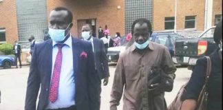 Mr Chinjenge (in suit) leaving the Lusaka Magistrate's Court this morning after the case was adjourned to December 8 this year for ruling on whether the case should be withdraw